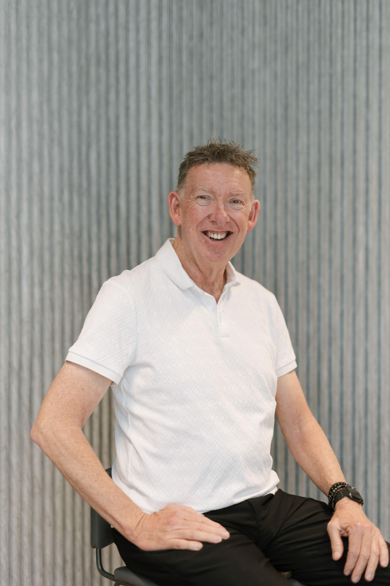 Geoff, host of Hepburn Retreats, smiling in a white polo shirt