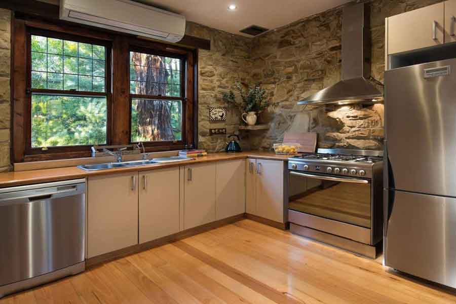 Kitchen with sandstone wall and stainless appliances